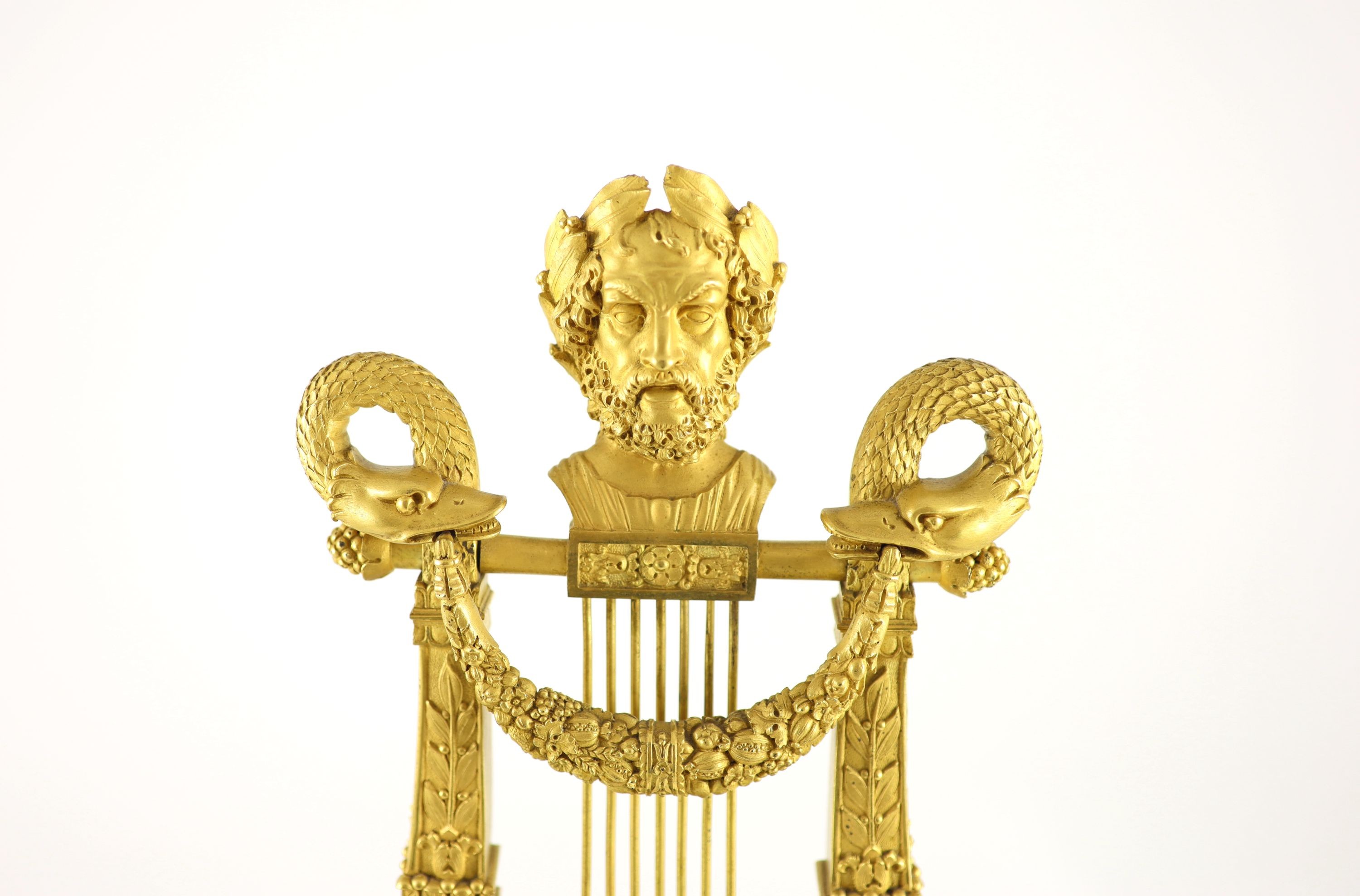A 19th-century French ormolu and marble lyre shaped mantel clock H 52cm. W 18cm. D 12cm.